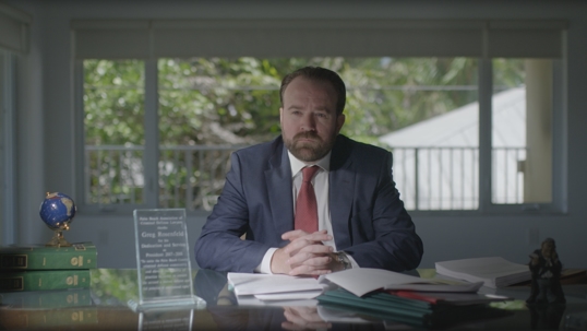 Attorney Greg Rosenfeld sitting at his desk